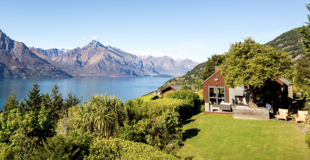 Red lodge near water and mountains.